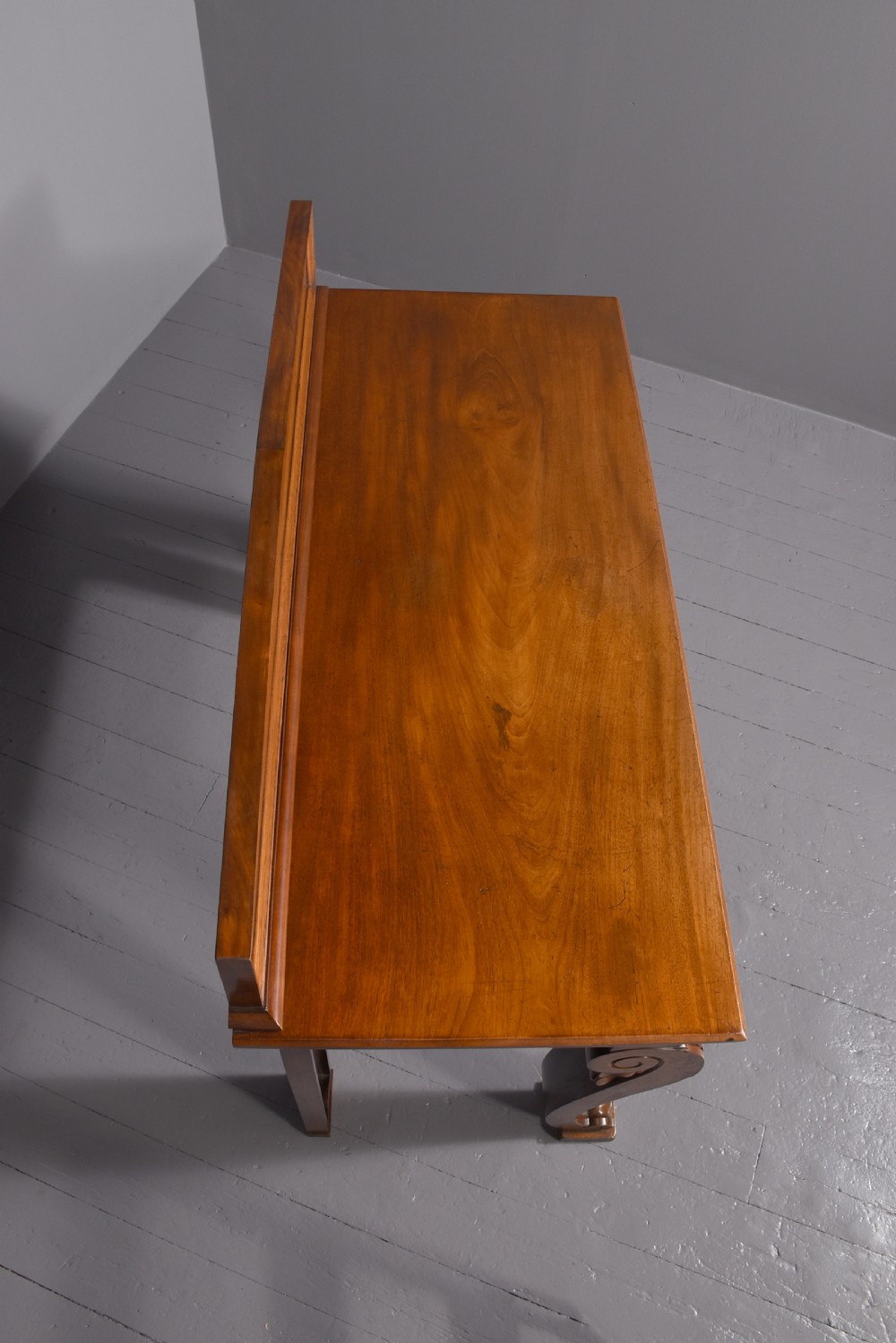 A William IV mahogany console table featuring a pedimented upstand, flame mahogany frieze, and acanthus leaf carved scroll front legs resting on plinth bases. View VI