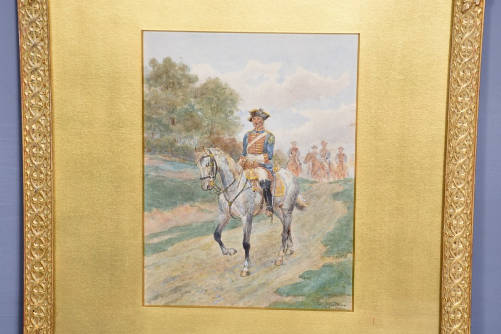 A set of three gilt-framed watercolour paintings depicting cavalry soldiers on horseback in varied rural landscapes. View III