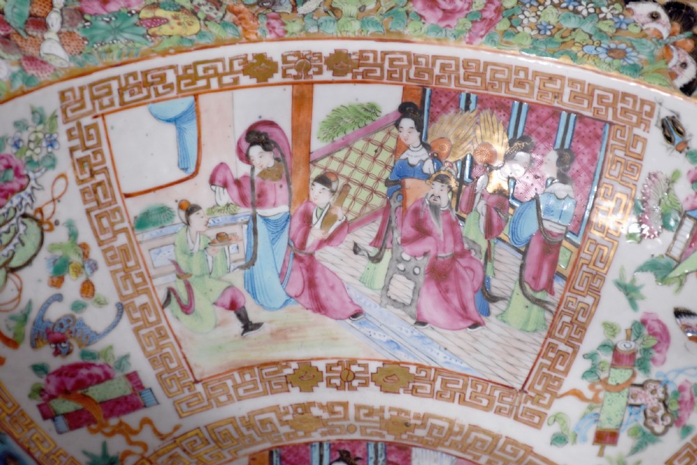 A large round Canton Famille Rose porcelain bowl decorated inside with hand-painted Mandarin figure scenes, floral borders, and gilded rims. View III