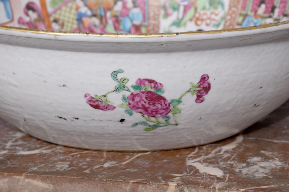 A large round Canton Famille Rose porcelain bowl decorated inside with hand-painted Mandarin figure scenes, floral borders, and gilded rims. View VII
