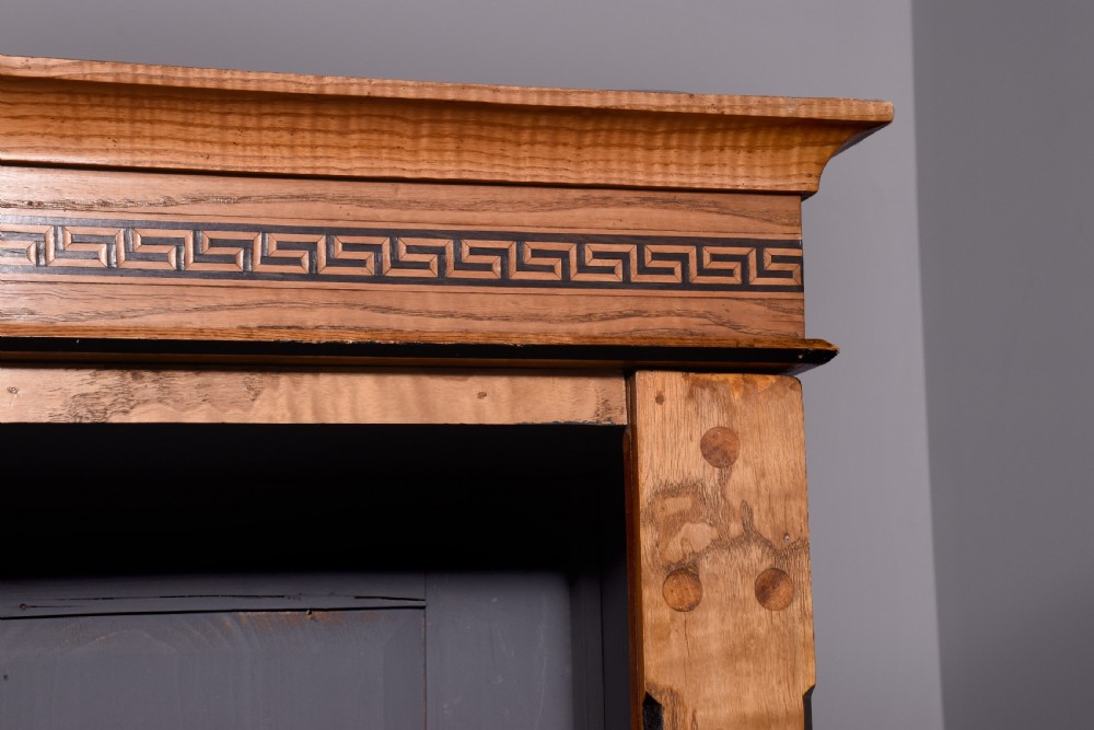 A large Victorian Arts and Crafts open bookcase crafted from warm brown elm featuring three vertical sections with decorative inlaid borders. View V