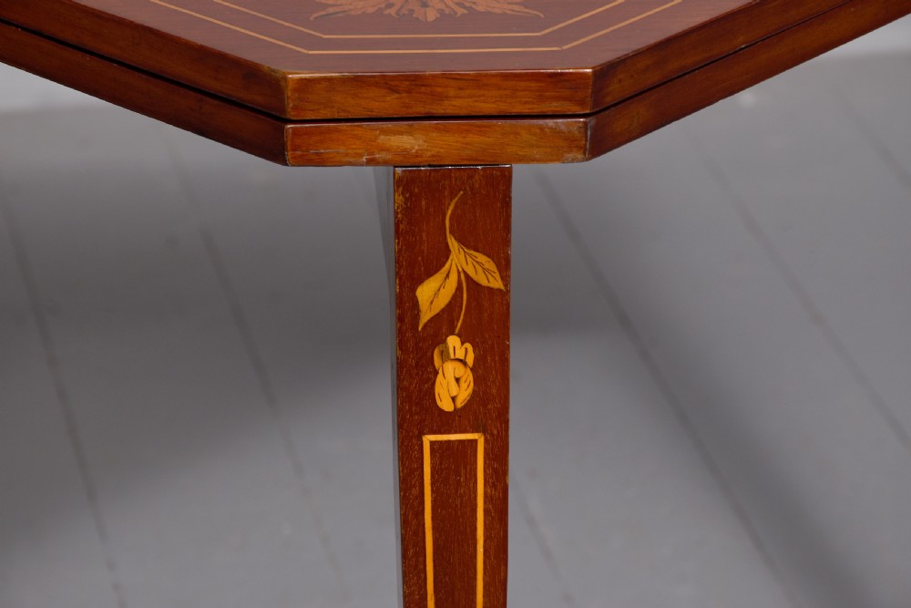 A triangular wooden Dutch card table featuring detailed floral marquetry inlay on the top surface and tapered square legs. View II