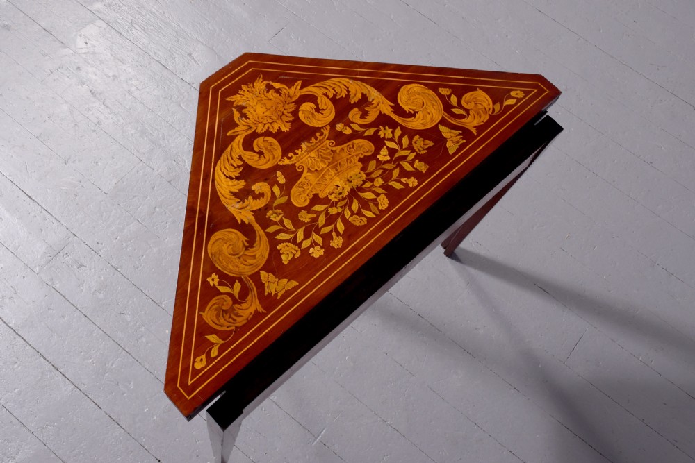 A triangular wooden Dutch card table featuring detailed floral marquetry inlay on the top surface and tapered square legs. View IV