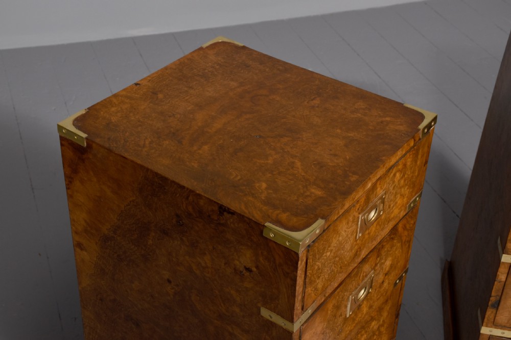 A pair of Victorian burr walnut military style small chests of drawers featuring flush brass handles, corner brackets, and four graduated drawers. View VI