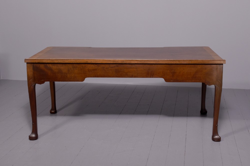 A large crossbanded mahogany library desk featuring three frieze drawers and slender cabriole legs. View V