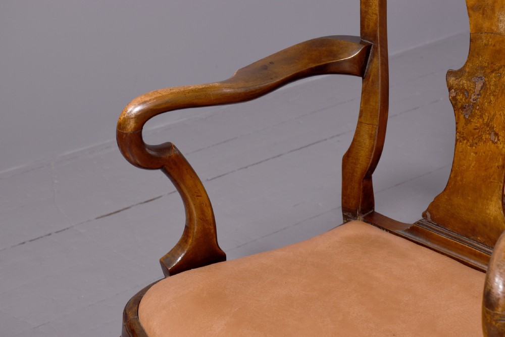 A set of ten George II walnut dining chairs with vasiform back splats, leather upholstery, and cabriole legs. View II