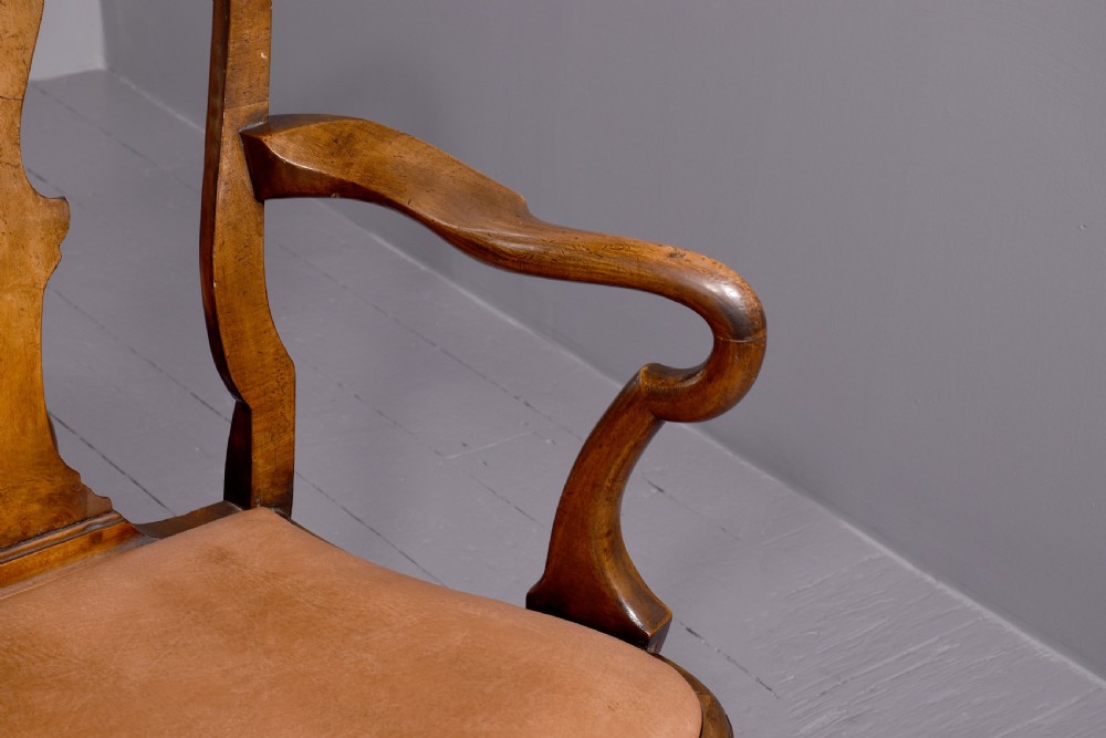 A set of ten George II walnut dining chairs with vasiform back splats, leather upholstery, and cabriole legs. View III