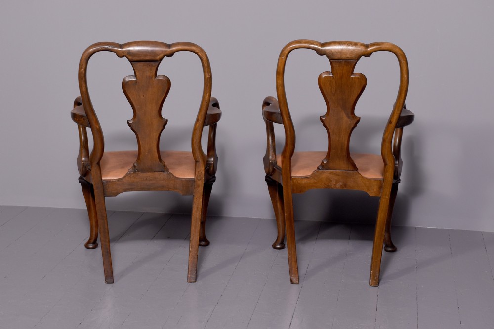 A set of ten George II walnut dining chairs with vasiform back splats, leather upholstery, and cabriole legs. View IV