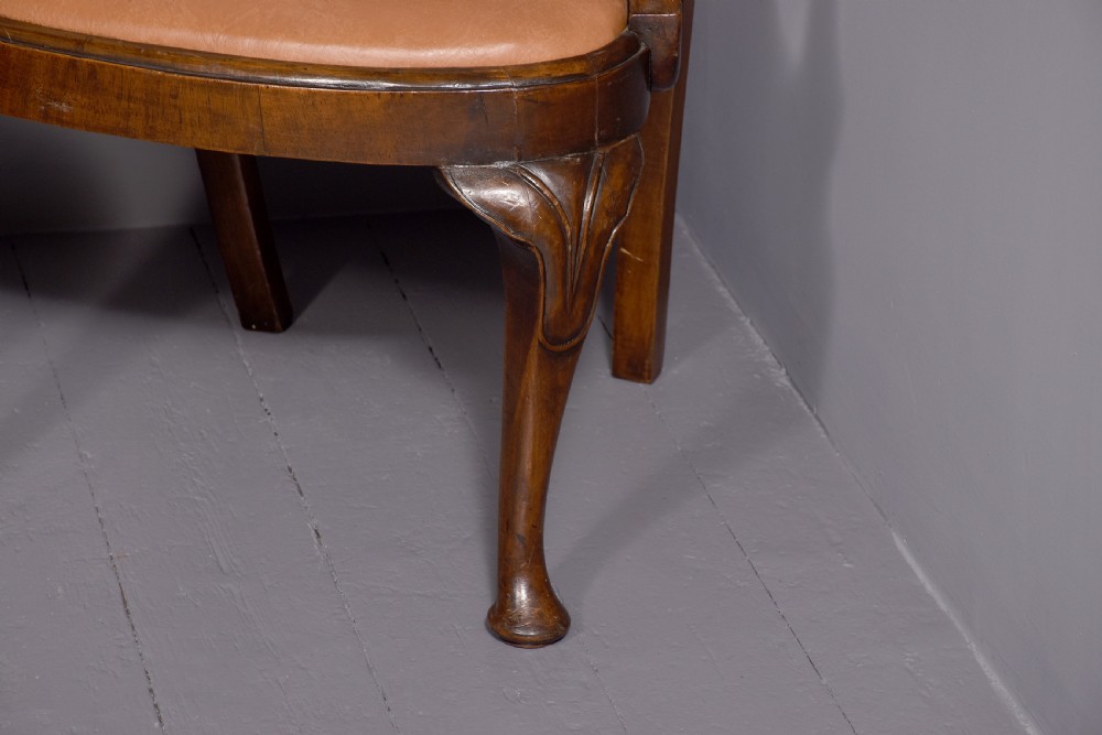 A set of ten George II walnut dining chairs with vasiform back splats, leather upholstery, and cabriole legs. View VI