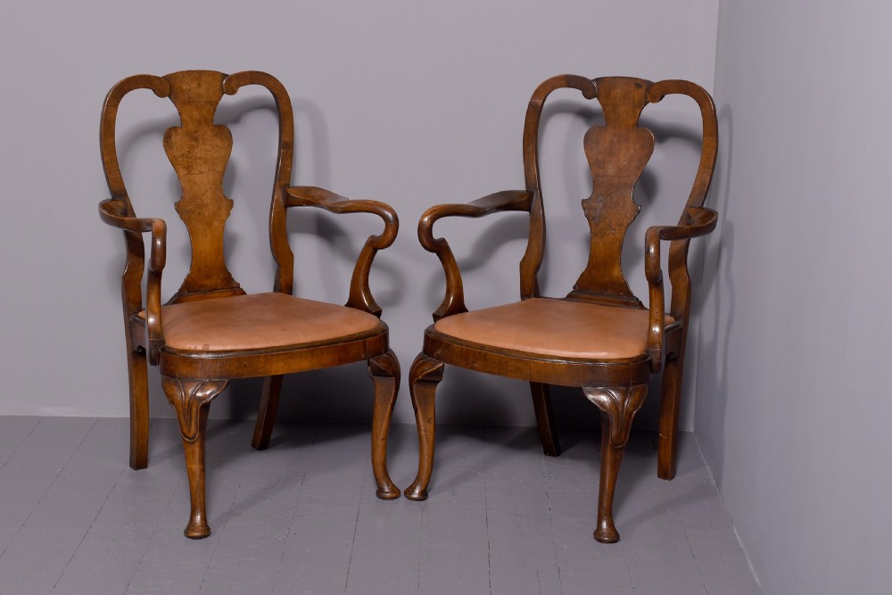 A set of ten George II walnut dining chairs with vasiform back splats, leather upholstery, and cabriole legs. View VII