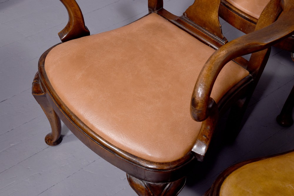 A set of ten George II walnut dining chairs with vasiform back splats, leather upholstery, and cabriole legs. View IX