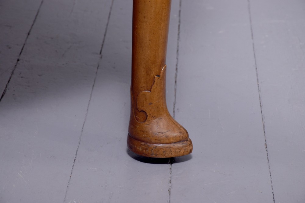 An oval antique timber extending dining table with tapered legs and sculpted pad feet. View III