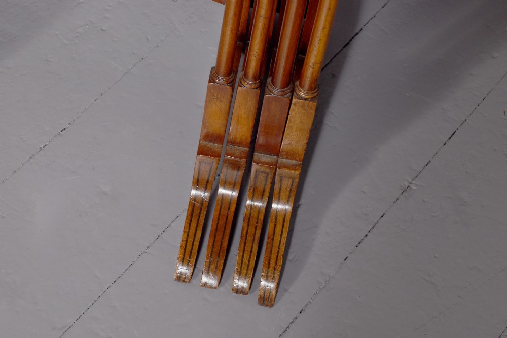 A set of four nested mahogany quartetto tables featuring rectangular crossbanded tops and slender turned legs. View II