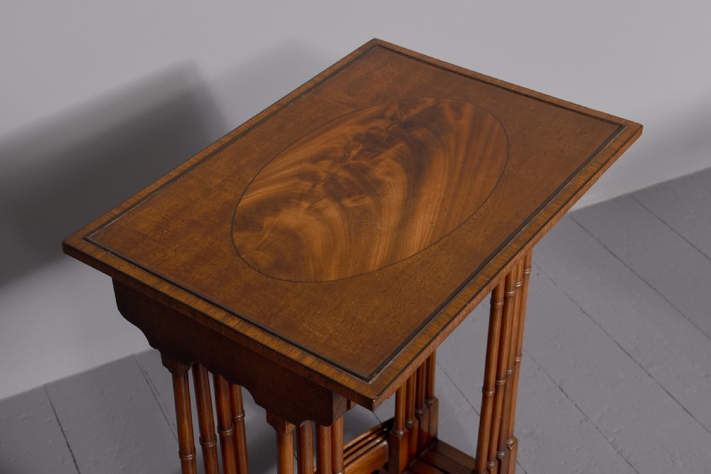 A set of four nested mahogany quartetto tables featuring rectangular crossbanded tops and slender turned legs. View III