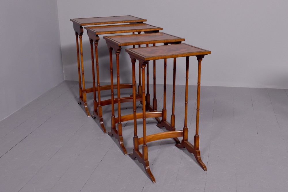 A set of four nested mahogany quartetto tables featuring rectangular crossbanded tops and slender turned legs. View IV