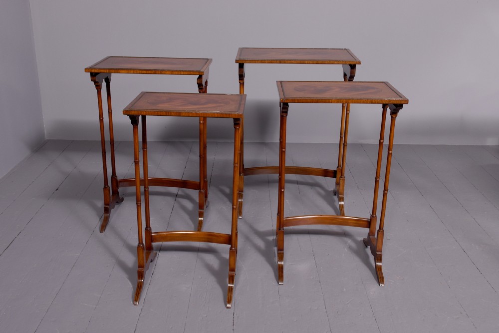 A set of four nested mahogany quartetto tables featuring rectangular crossbanded tops and slender turned legs. View V