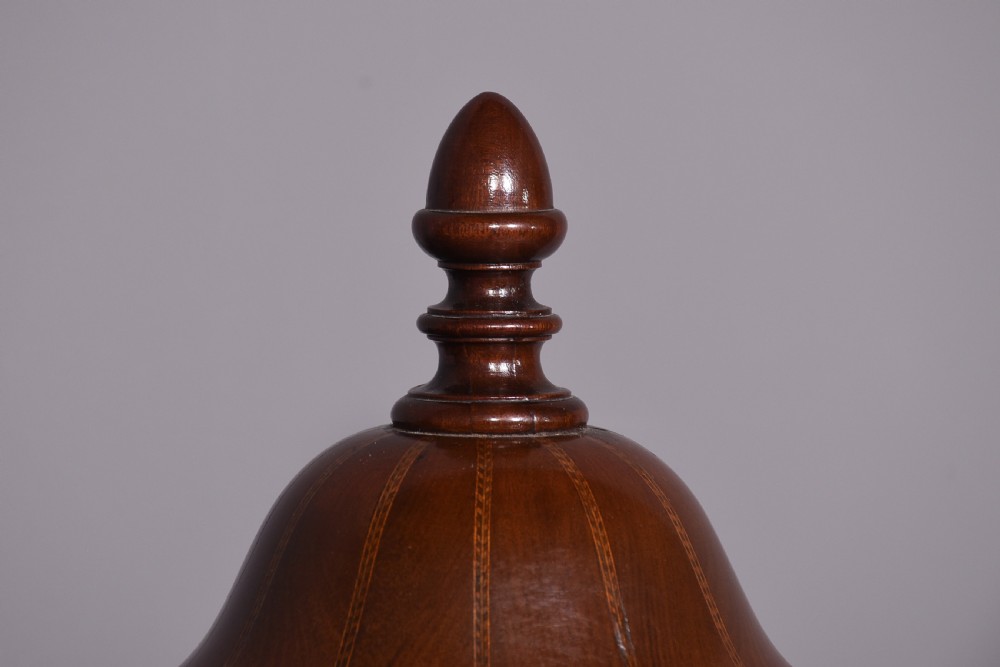 A pair of neoclassical mahogany urn-shaped cutlery boxes with fine line inlay, turned finials, and silver-toned keyhole escutcheons. View II