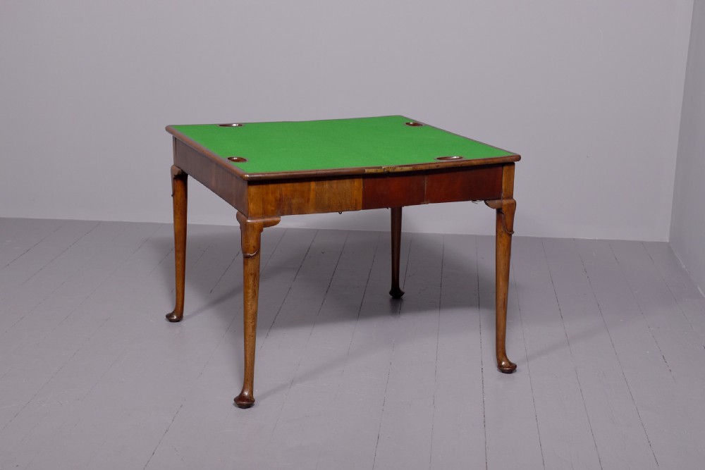 A George II mahogany card table featuring a rectangular fold-over top and slender cabriole legs terminating in pad feet. View II