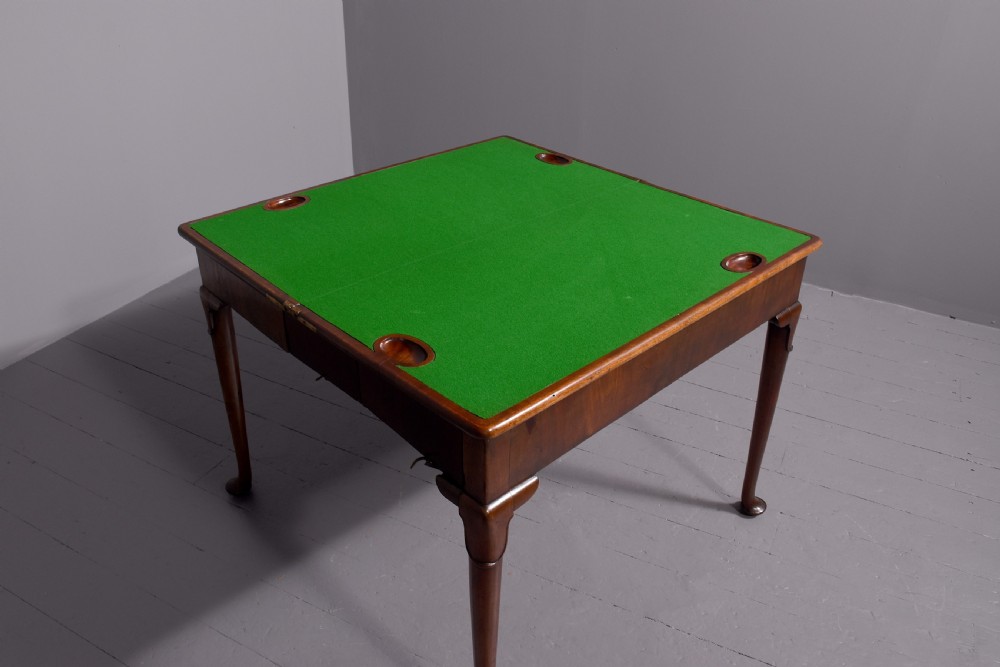 A George II mahogany card table featuring a rectangular fold-over top and slender cabriole legs terminating in pad feet. View III