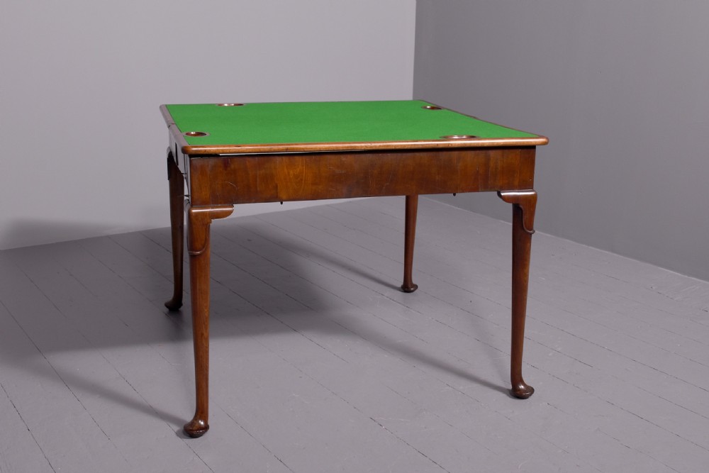 A George II mahogany card table featuring a rectangular fold-over top and slender cabriole legs terminating in pad feet. View IV