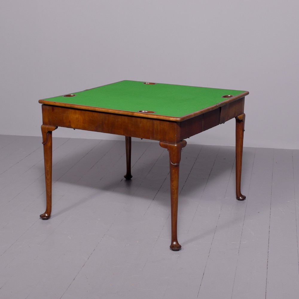 A George II mahogany card table featuring a rectangular fold-over top and slender cabriole legs terminating in pad feet. View V