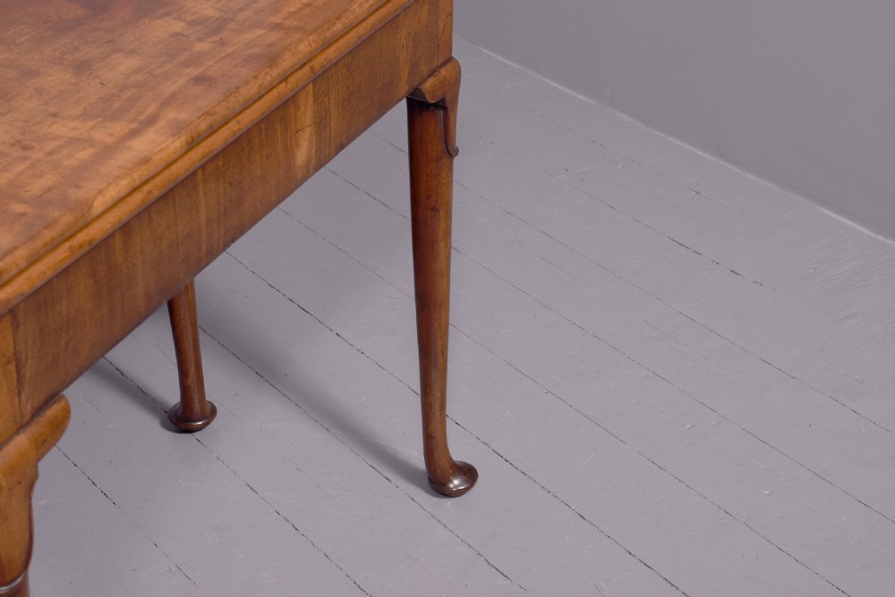 A George II mahogany card table featuring a rectangular fold-over top and slender cabriole legs terminating in pad feet. View VI