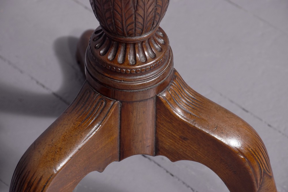 A George III mahogany occasional table featuring a circular top raised on a fluted central pedestal and a tripod base with carved cabriole legs. View III