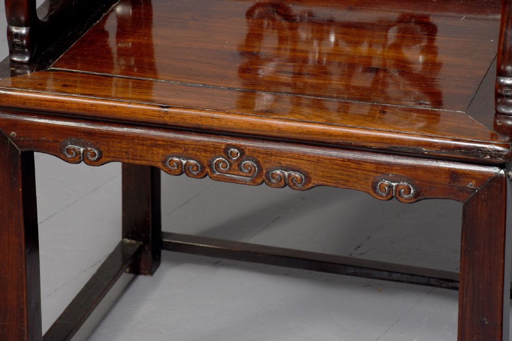 A pair of dark polished hardwood Chinese Qing Dynasty throne chairs featuring intricate openwork carved back splats with longevity symbols and carved armrests. View III