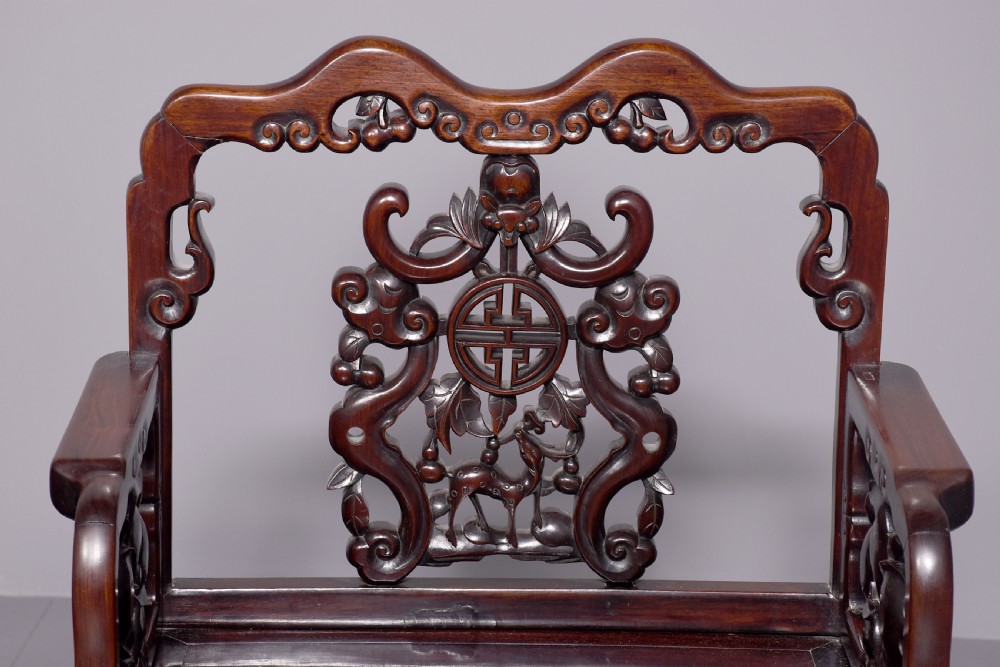 A pair of dark polished hardwood Chinese Qing Dynasty throne chairs featuring intricate openwork carved back splats with longevity symbols and carved armrests. View IV