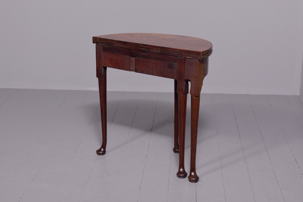 An 18th-century George III mahogany D-shaped card table with cabriole legs and pad feet shown in a folded configuration. View II