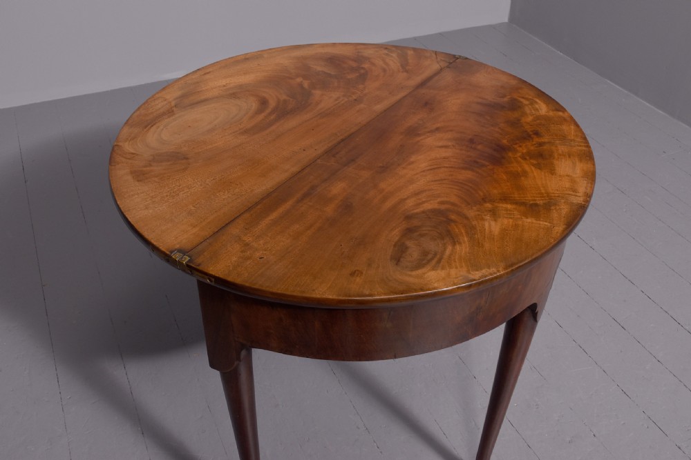 An 18th-century George III mahogany D-shaped card table with cabriole legs and pad feet shown in a folded configuration. View V