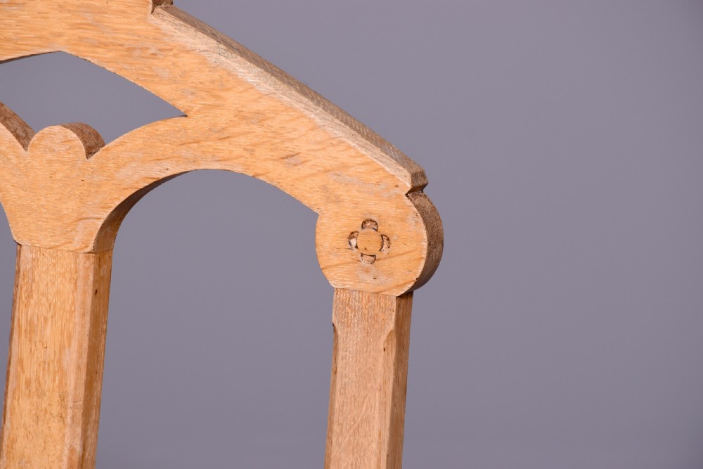 A pair of light oak side chairs featuring Gothic arched cut-outs on the backrests, turned front legs, and patterned gold velvet upholstery. View VI