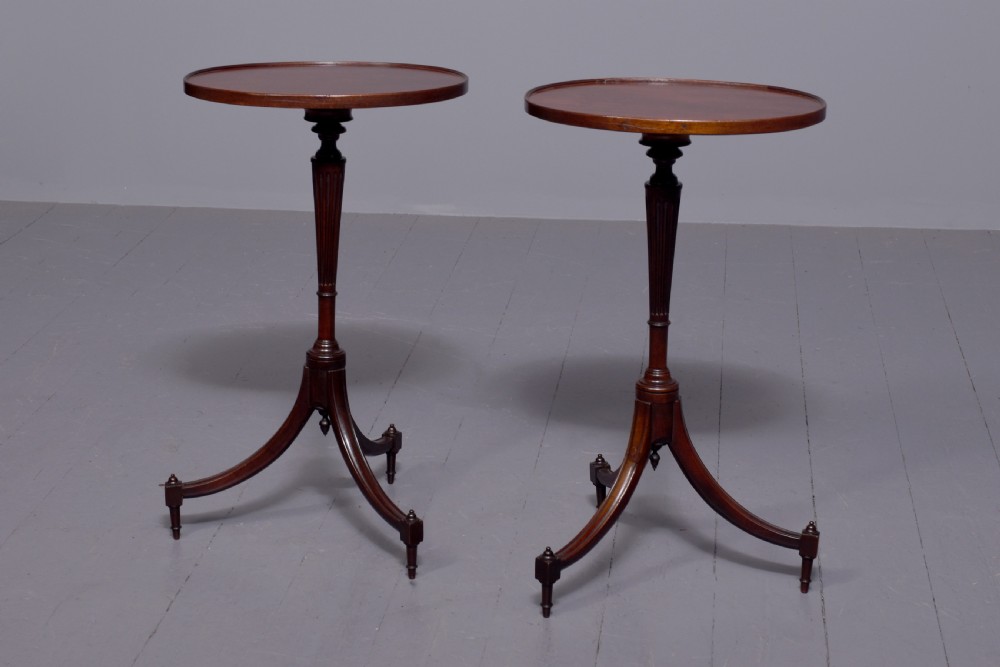 A pair of Regency dark mahogany wine tables featuring circular dish tops, fluted tapered stems, and swept tripod legs. View VII