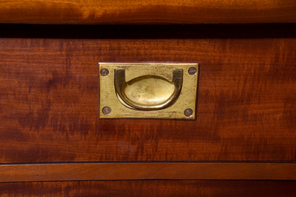 A large mid-Victorian mahogany bookcase featuring a three-bay open upper section with adjustable shelves set above a three-door cupboard base with oval veneered panels. View VI