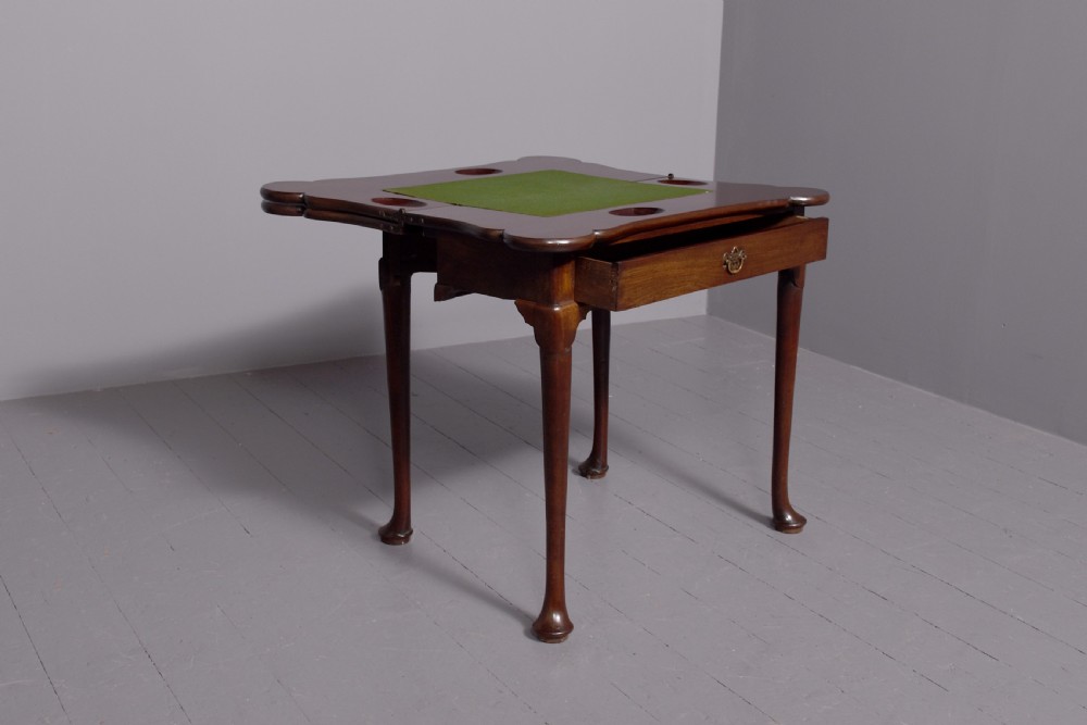 A George III mahogany triple top games table featuring cabriole legs ending in pad feet and a single frieze drawer with a brass handle. View VIII