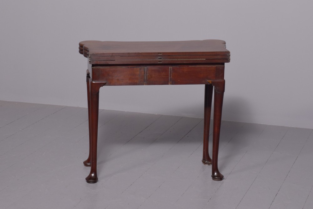 A George III mahogany triple top games table featuring cabriole legs ending in pad feet and a single frieze drawer with a brass handle. View IX