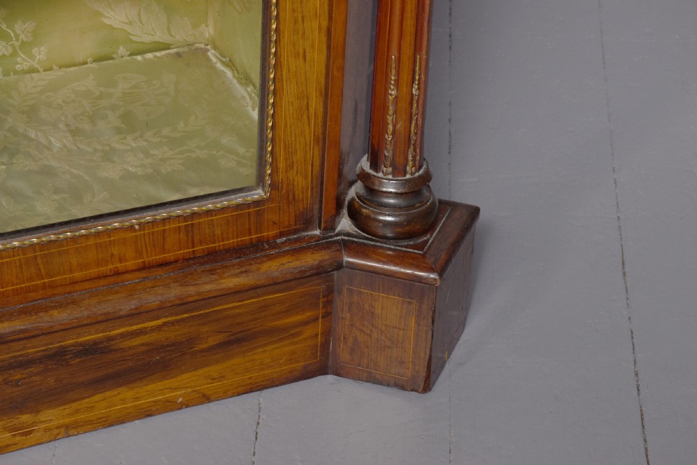 A mid-Victorian burr walnut credenza featuring a central panel door with floral marquetry inlay, flanked by two glazed display doors housing fabric-lined shelves. View III