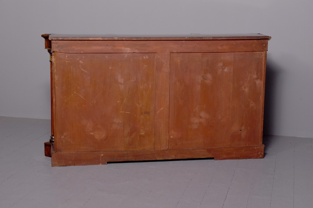 A mid-Victorian burr walnut credenza featuring a central panel door with floral marquetry inlay, flanked by two glazed display doors housing fabric-lined shelves. View XI