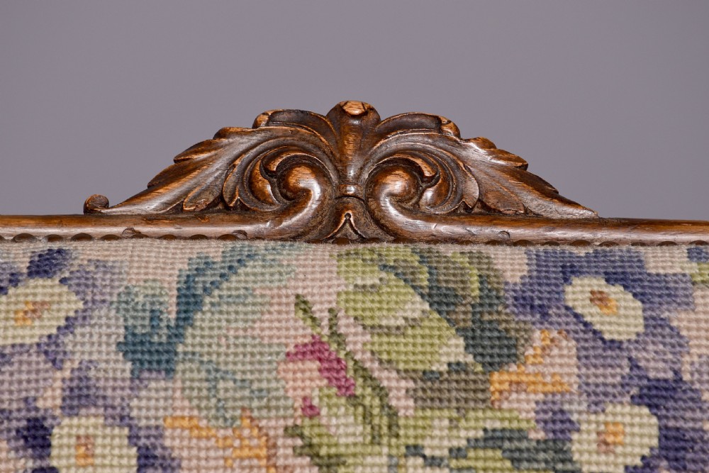 A Victorian prie-dieu chair featuring floral needlepoint upholstery on a carved wood frame with turned front legs and brass castors. View III