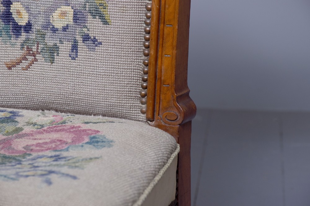 A Victorian prie-dieu chair featuring floral needlepoint upholstery on a carved wood frame with turned front legs and brass castors. View VII