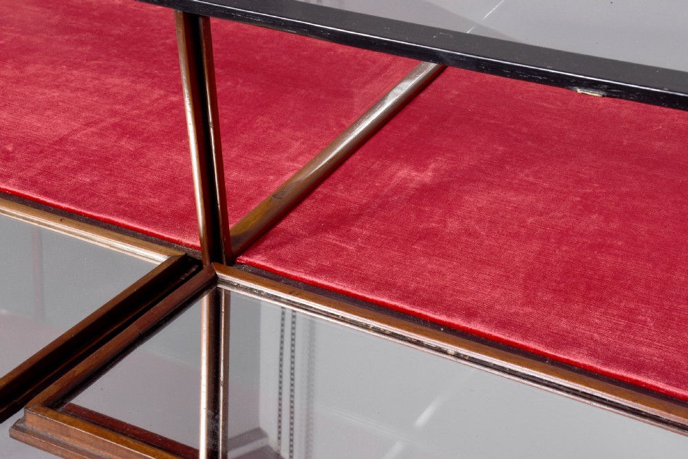 A large oval mahogany display cabinet featuring curved glass sides, red velvet lining, carved cabriole legs, and claw and ball feet. View IX