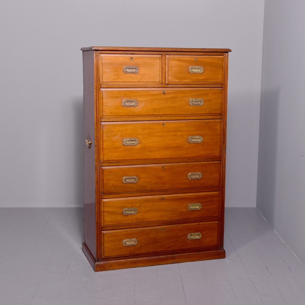 A tall Victorian mahogany military secretaire chest featuring multiple graduated drawers with recessed brass handles.