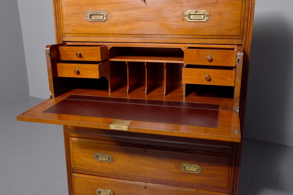 A tall Victorian mahogany military secretaire chest featuring multiple graduated drawers with recessed brass handles. View III