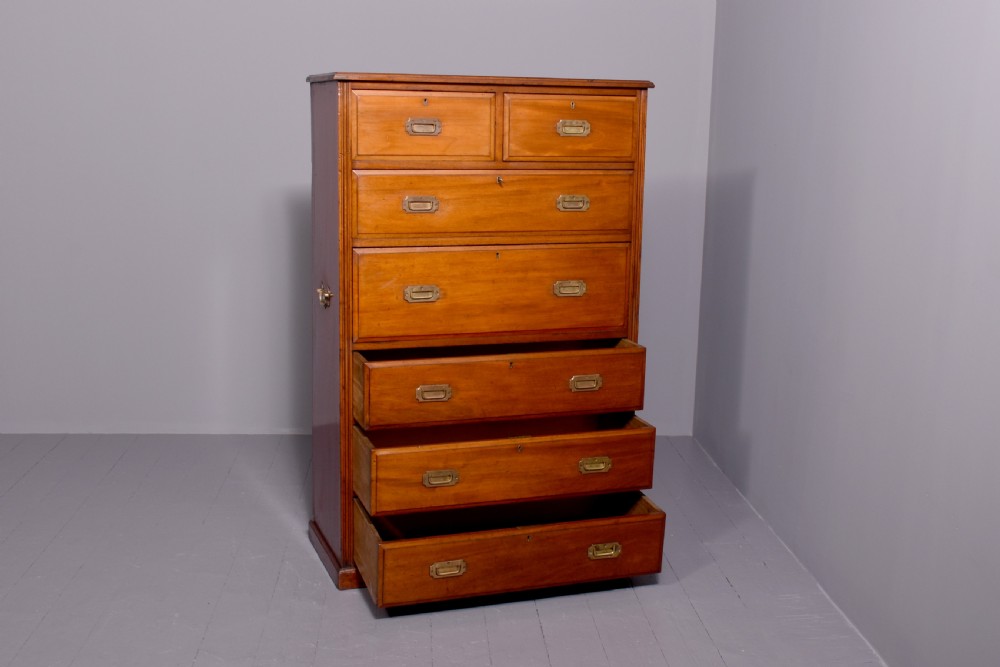 A tall Victorian mahogany military secretaire chest featuring multiple graduated drawers with recessed brass handles. View V