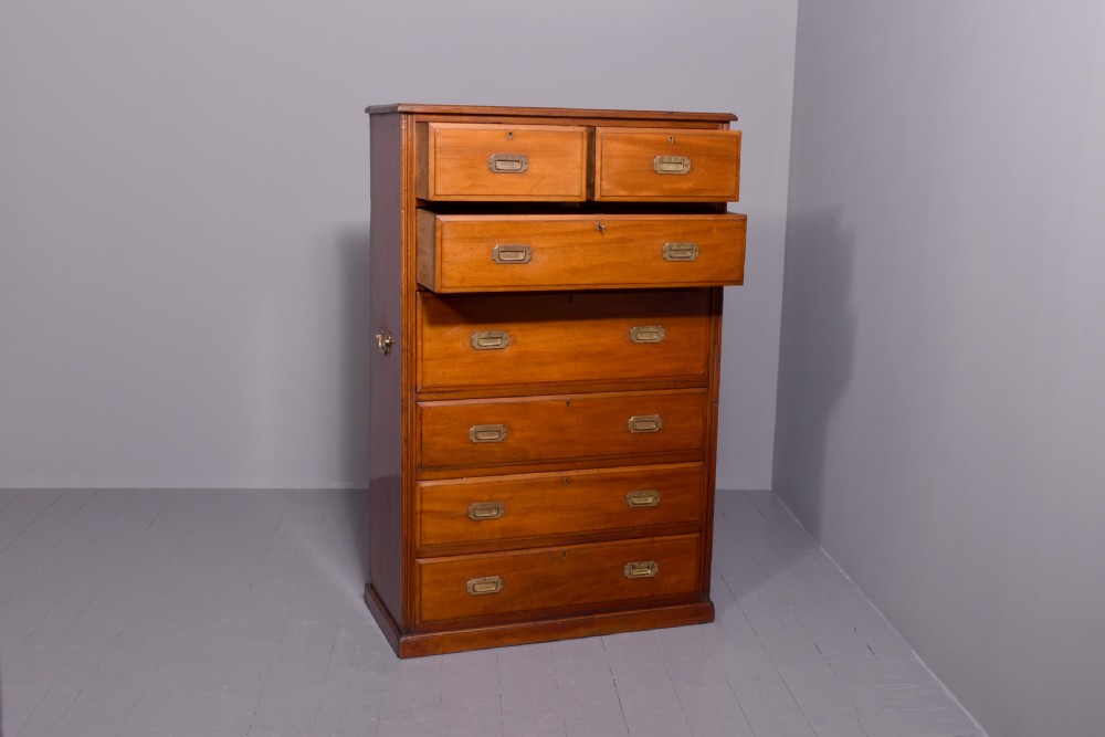 A tall Victorian mahogany military secretaire chest featuring multiple graduated drawers with recessed brass handles. View VI