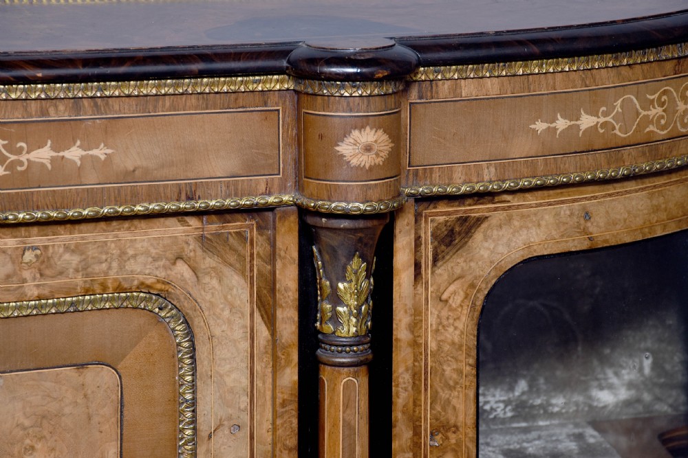 A Victorian burr walnut credenza featuring a central marquetry inlaid panel door flanked by two curved glazed display cupboards and gilt-bronze mounts. View III