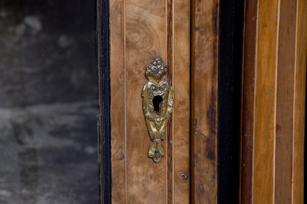 A Victorian burr walnut credenza featuring a central marquetry inlaid panel door flanked by two curved glazed display cupboards and gilt-bronze mounts. View VIII