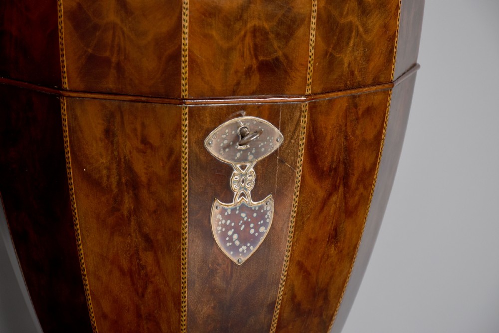 A pair of faceted mahogany cutlery urns featuring geometric stringing inlay, turned finials, and silver keyhole escutcheons on square pedestals. View III