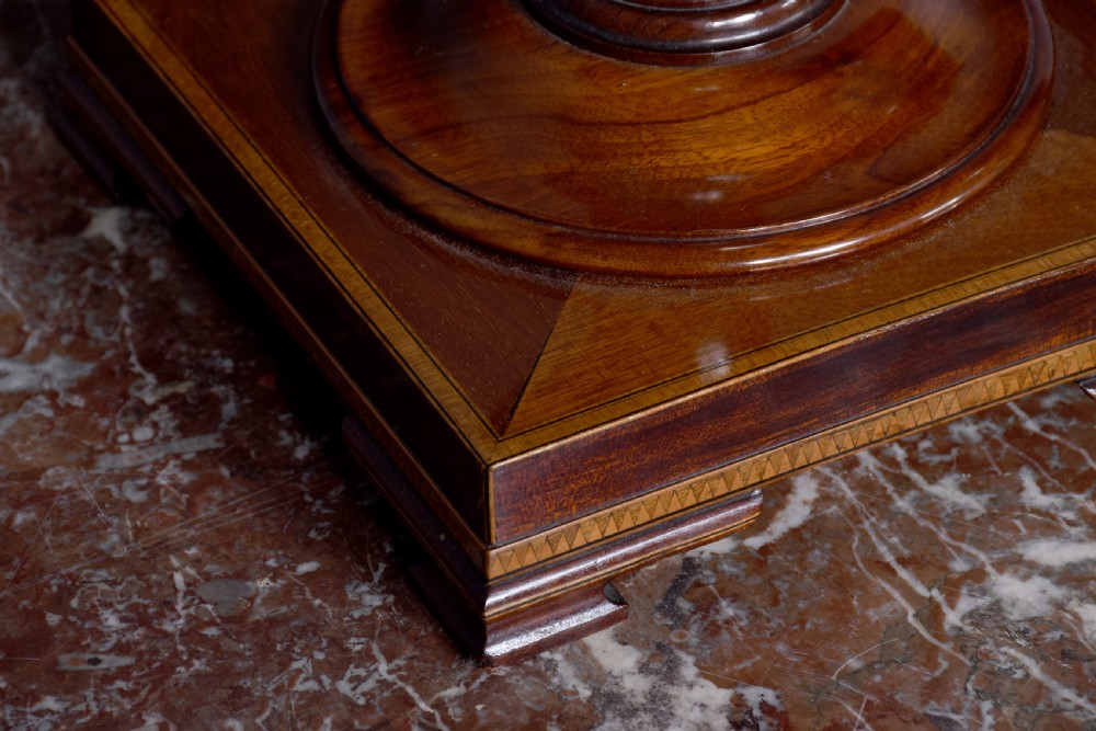 A pair of faceted mahogany cutlery urns featuring geometric stringing inlay, turned finials, and silver keyhole escutcheons on square pedestals. View VI