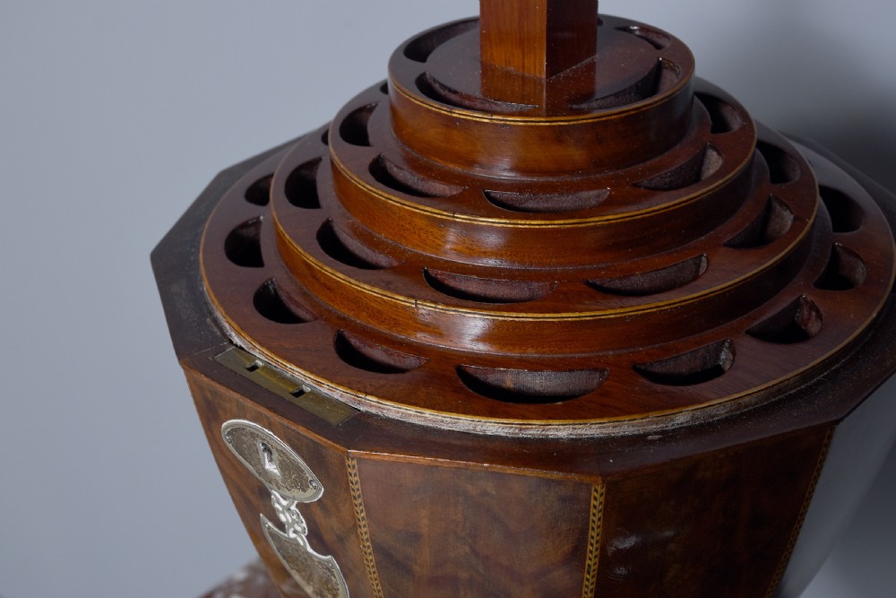 A pair of faceted mahogany cutlery urns featuring geometric stringing inlay, turned finials, and silver keyhole escutcheons on square pedestals. View X